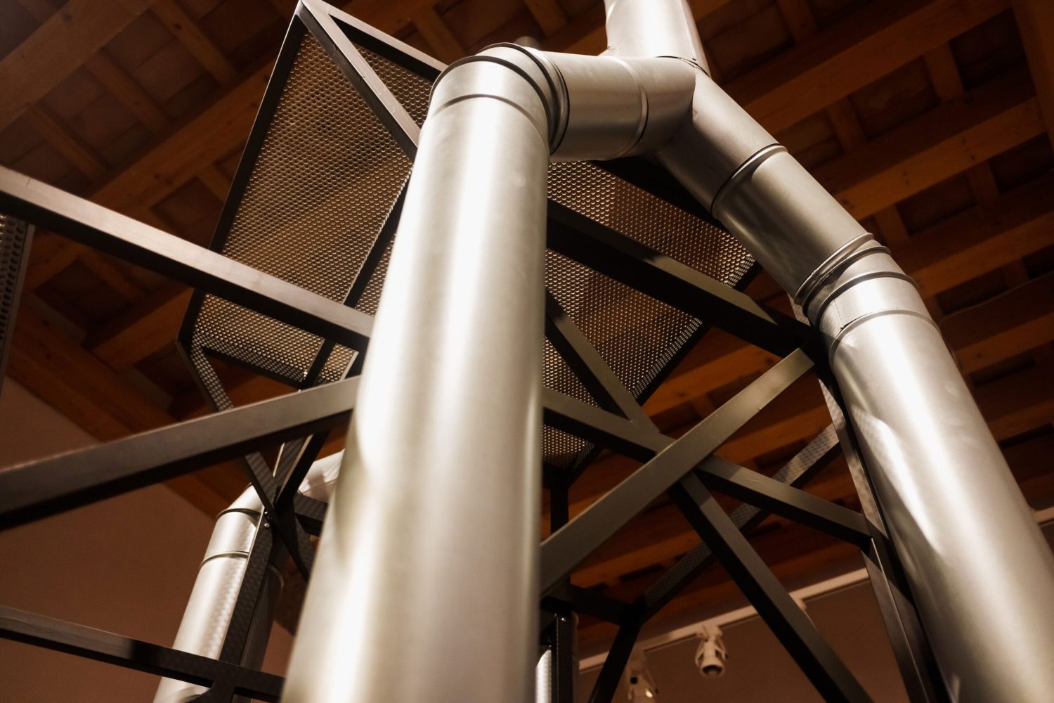 vertical-metal-pipes-inside-an-industrial-warehous-2024-10-18-12-02-55-utc
